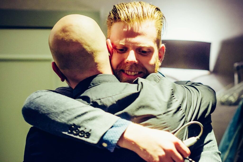 Two men embracing during an immersion